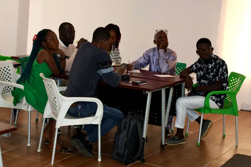 Team members seated around a table during a planning session.